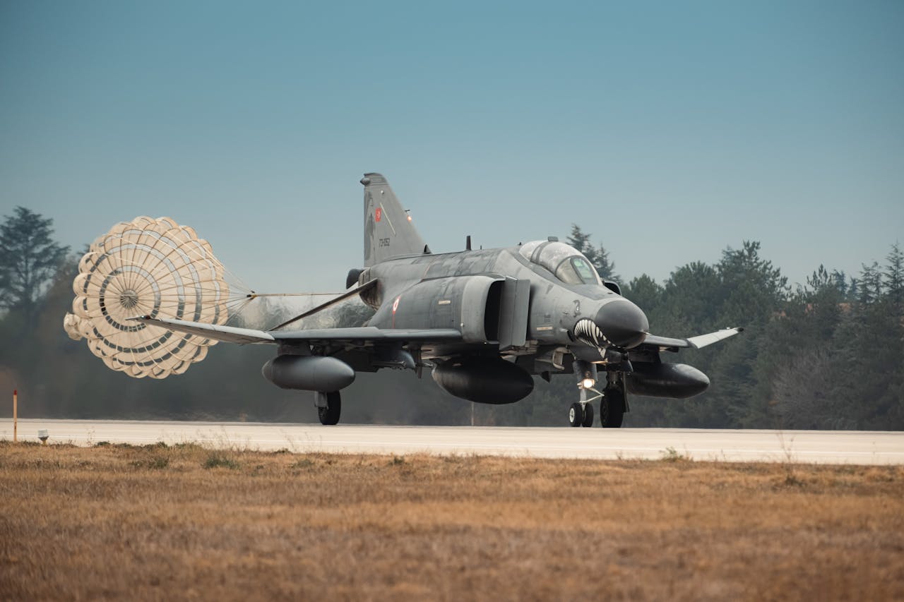 About Turkish Air Force jet fighter landing with parachute deployed on runway in Türkiye.