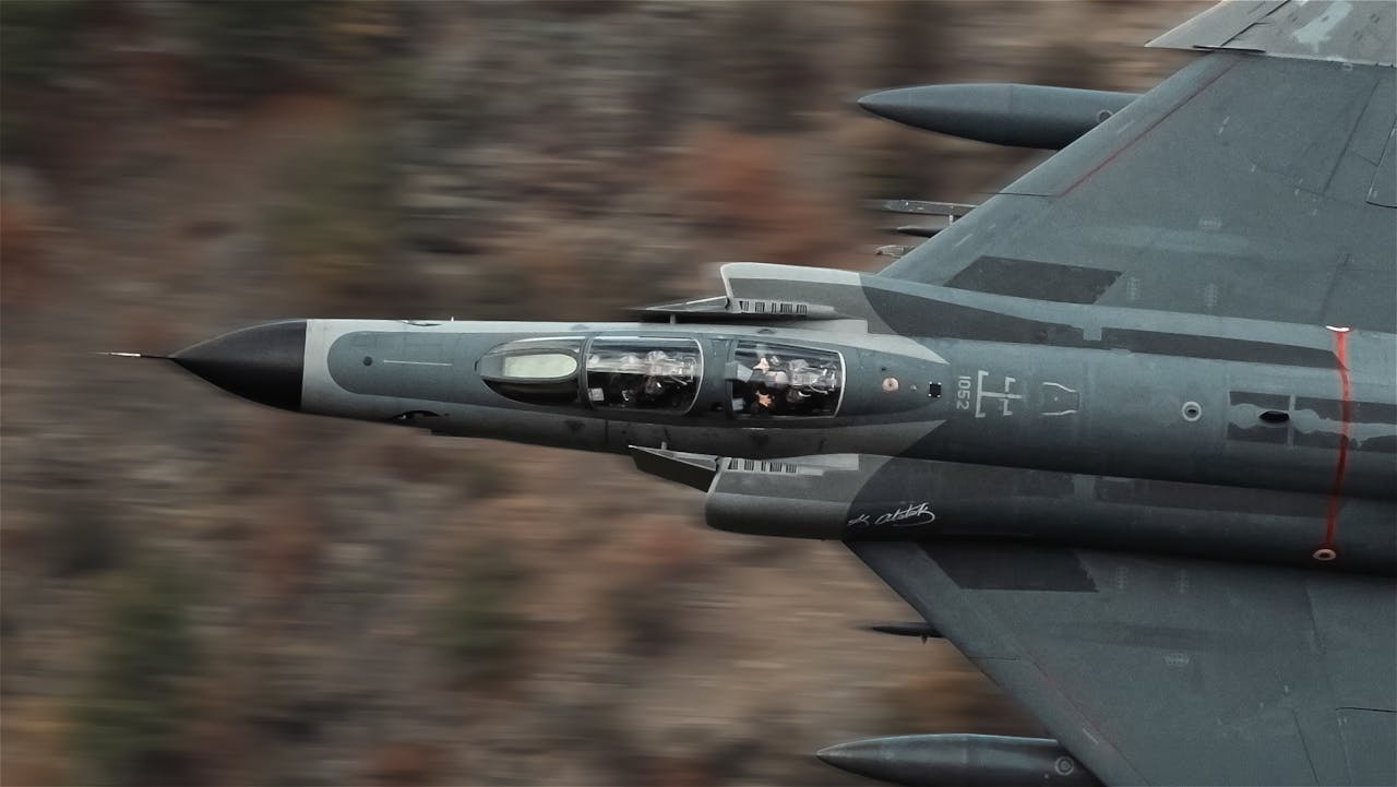 High-speed Turkish military jet flying over rugged terrain, showcasing aviation prowess.
